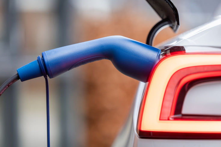 Blue Voldt Type 2 EV charging cable connector plugged into the charging port of a white car