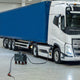 Mobile DC fast charger positioned next to a blue and white electric truck