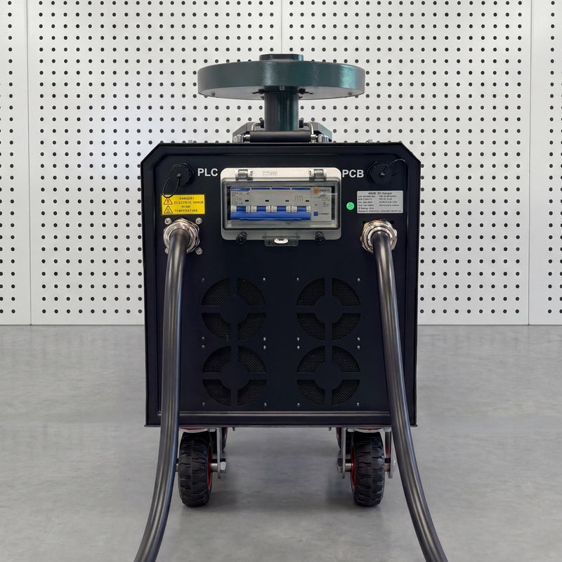 Rear view of a portable DC fast charger showing the circuit breaker panel